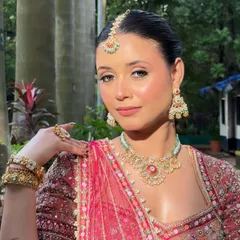 A classic portrait pose, showcasing the entire makeup and jewelry look.