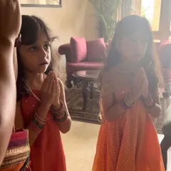 Two young students listen with rapt attention during our Vijayadashami puja. This ceremony, known as Vidyarambham, marks an auspicious beginning to their journey in learning the arts, and we honor these traditions as part of our curriculum.