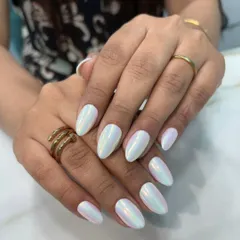 A beautiful iridescent white chrome, often called "glazed donut" nails. This finish gives a subtle, pearly sheen that catches the light beautifully, perfect for an elegant and trendy look.