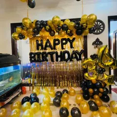 This black and gold birthday setup is perfect for a chic and glamorous celebration. It includes a golden fringe backdrop, a "HAPPY BIRTHDAY" balloon banner, and an organic balloon arrangement with the age "34" prominently displayed.