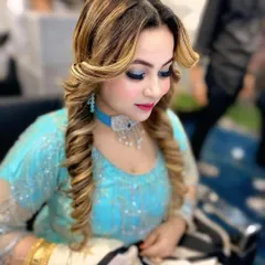 A close-up of the party hairstyle, showing the detail in the curled sections and the way the highlights catch the light.