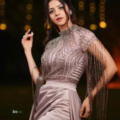 This shot captures the full elegance of the outfit and the moment. The combination of the detailed top and the flowing skirt is perfect for a glamorous event photography session.