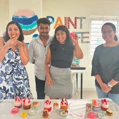 A happy group poses with their finished dessert candles, showcasing the fun and delicious-looking results of our popular candle making workshop.