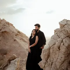 Using the unique rock formations of the Dubai desert to frame the couple. This shot highlights the rugged beauty of the landscape and the couple's serene connection within it.
