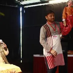 An artist explains the nuances of a particular puppet style during a presentation at the Dhaatu International Puppet Festival.