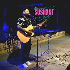 On stage for a "Sushant Live" event. This is my typical solo setup with my acoustic guitar and microphone, ready to entertain the crowd.