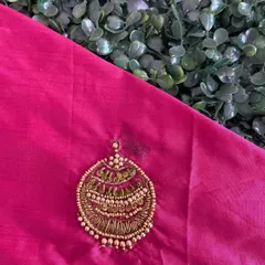 A 'jhumka' or earring-style motif created with Zari thread and beadwork. This type of intricate butta can be used to embellish the body of a blouse or lehenga.