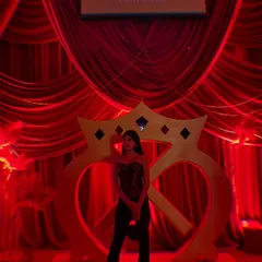 Posing at the Gaurav Gupta show. The dramatic red lighting and backdrop complemented the black and gold of my outfit perfectly.