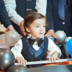 It's these unscripted, in-between moments that are pure magic. We focus on capturing your child's genuine expressions and personality, like this little one's curious gaze during his grand birthday entrance.