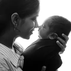 The quiet, tender connection between a mother and her newborn. This black and white portrait uses soft, natural light to highlight the emotion of the moment, creating a timeless and classic family photograph you will cherish forever.