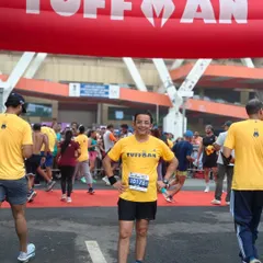 A member standing proudly at the Tuffman race entrance. We are always ready to take on new challenges and push our limits.