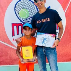 Avyaan with his coach after winning the Under 8 title, a fantastic start to his tennis journey.
