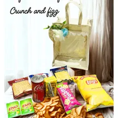 The perfect combo of crunch and fizz. This image shows all the contents of the Crunchy Hamper, including a variety of chips, snacks, and drinks.