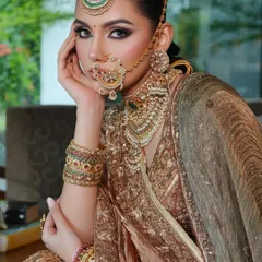 Another view of this regal look, highlighting the bride's majestic presence and the flawless draping of her dupattas.