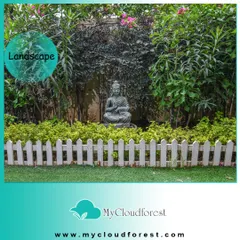 A simple Buddha statue placed within a dense garden bed can create a powerful focal point. Here, it is framed by a classic white picket fence and lush foliage, adding a touch of tranquility to a traditional garden layout.