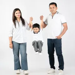That big, happy smile says it all. A playful swing between mom and dad always brings out the best giggles. This is what happy childhood memories look like.