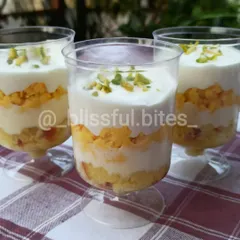 A closer look at three of my Rasmalai Fusion dessert cups. You can see the layers of moist cake and creamy topping, garnished with finely chopped pistachios.