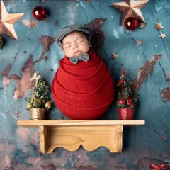 A little gentleman on the shelf. This creative Christmas themed newborn portrait is a unique and charming way to capture your baby's first holiday.