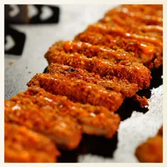 This detailed shot showcases the texture and preparation of our Dukkah Spiced Cottage Cheese. Each piece is perfectly coated and fried, ready to be served as an impressive appetizer that blends Middle Eastern spice with Indian paneer.