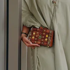 Here is a close up of my handcrafted wooden box clutch. I focused on the intricate details, from the polished wood blocks to the delicate embellishments, to create a piece that feels both rustic and luxurious. It's a unique accessory for a modern, earthy style.