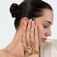 Enhance your wrist with our classic crafted hand harness. This piece features a beautiful combination of gold tones and crystals, perfect for adding glamour to your wedding or festive fashion.