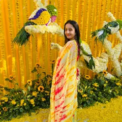 Posing against the intricate floral decor at the Jaipur Haldi. I work with decorators to ensure the event's theme and visual appeal are perfectly aligned with the client's vision.