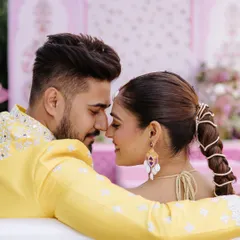 An intimate and playful moment between the couple during their Haldi ceremony, their noses touching in a sweet "eskimo kiss."