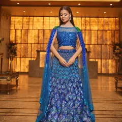 Make a grand entrance at your sangeet or reception with this showstopping peacock-inspired lehenga. The vibrant blue sequins and unique feather-like design create a look that is both glamorous and unforgettable.