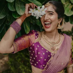 A joyful close-up of the client in her purple half-saree. The playful pose captures the happy spirit of the occasion this outfit was designed for.