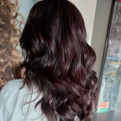 This deep red and violet look is perfect for dark hair. By blending tones from the red family, I created a color that is rich and noticeable without being overly bright, adding depth and interest to the client's hair.