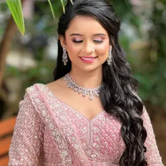 For the modern bride who loves a soft, romantic glow. This delicate diamond necklace and earring set is perfect for an engagement or reception. It provides that touch of sparkle without overpowering the intricate details of the pink lehenga.