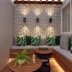 A textured 3D tile wall serves as a stunning backdrop for this cozy seating area. The wall is highlighted by modern sconces, while the built-in bench with tropical-print cushions adds comfort and style.