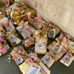 A stunning display of gifts for a 40th birthday party. We can create a cohesive set of personalized favors for any milestone, ensuring every guest leaves with a beautiful and meaningful memento.