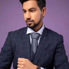 A classic pose for a corporate portrait. The three-piece suit and watch add to the professional look, making it perfect for a business leader or executive.