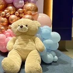 A close-up of the large teddy bear prop I used for the "We Can Bearly Wait" baby shower. These props add a cute and cuddly element to the decoration and are great for photos.