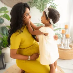 A tender moment between mother and daughter. These are the precious, unscripted interactions that tell the story of your family's love as you await your new arrival.