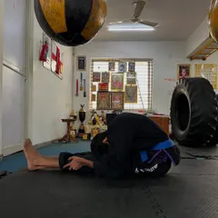 A seated forward fold stretch. This is essential for lengthening the hamstrings and lower back after a tough training session.