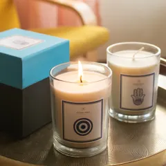 I designed this collection to bring positive energy into your space. The Evil Eye candle, scented with Apple Cinnamon, is lit here, creating a protective and comforting glow. It's a thoughtful gift for corporate clients or anyone needing a touch of good fortune.