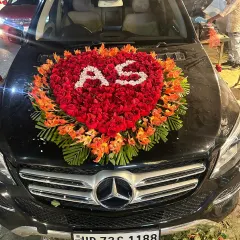 I offer on-location wedding car decoration across Ghaziabad and Noida. This design features a heart made of fresh red roses with the couple's initials, creating a personalized and elegant look for the groom's car.