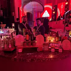 For a Japanese-themed event, we designed this circular bar with dramatic red lighting and custom menu stands. Our bartenders even wore themed attire to complete the immersive experience.