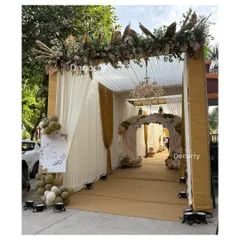 An elegant tented entrance for a rustic teddy bear party. The walkway is lined with drapes and leads to a beautifully decorated archway, creating a sophisticated first impression.