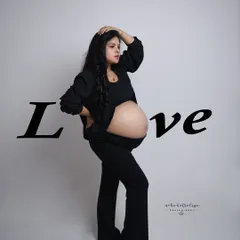 A powerful stance with the word "Love" overlaid. This image is a bold declaration of the love and strength that defines motherhood.