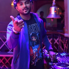 At the decks, ready to drop the next track. I bring my own style and energy, mixing everything from Bolly music to big room anthems for an unforgettable party.