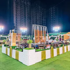 A wide-angle view of our modern white and gold buffet setup, featuring unique hanging displays for kebabs. This contemporary design adds a touch of luxury and sophistication to any wedding or corporate event.