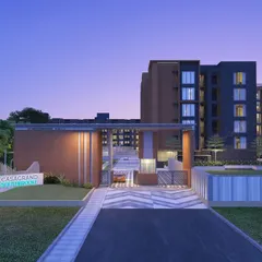 The entrance to Casagrand SouthBrooke at dusk, where architectural lighting highlights the clean, contemporary forms of the gateway and building facade.