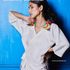 Insanely detailed. The collar on this white wrap top is a work of art in itself, with colorful, hand-embroidered patterns that make it one of a kind.