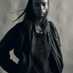 A dynamic black and white portrait with motion blur in the hair. This technique adds a sense of raw energy and movement to the shot, making it feel alive and untamed.