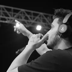 It's not just about the beats, it's about the voice too. A black and white shot of me on the mic, connecting with the crowd during a festival set.