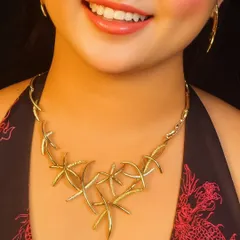 A unique, modern gold-toned necklace with a starfish-like design. This is a statement piece perfect for a cocktail party or a beach wedding.