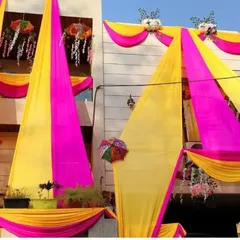 A closer look at the details of our house exterior draping. We ensure the fabrics are arranged beautifully and securely, adding floral touches and umbrellas for extra decoration.